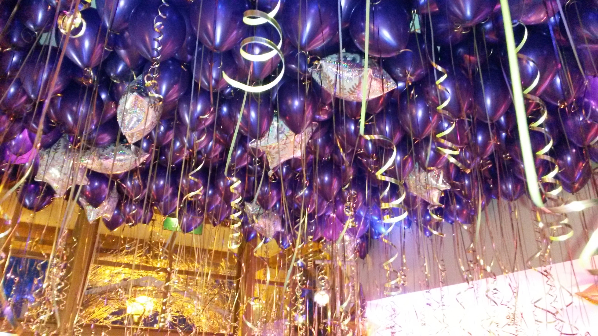Purple latex balloon ceiling fill with statement snowflake foil balloons