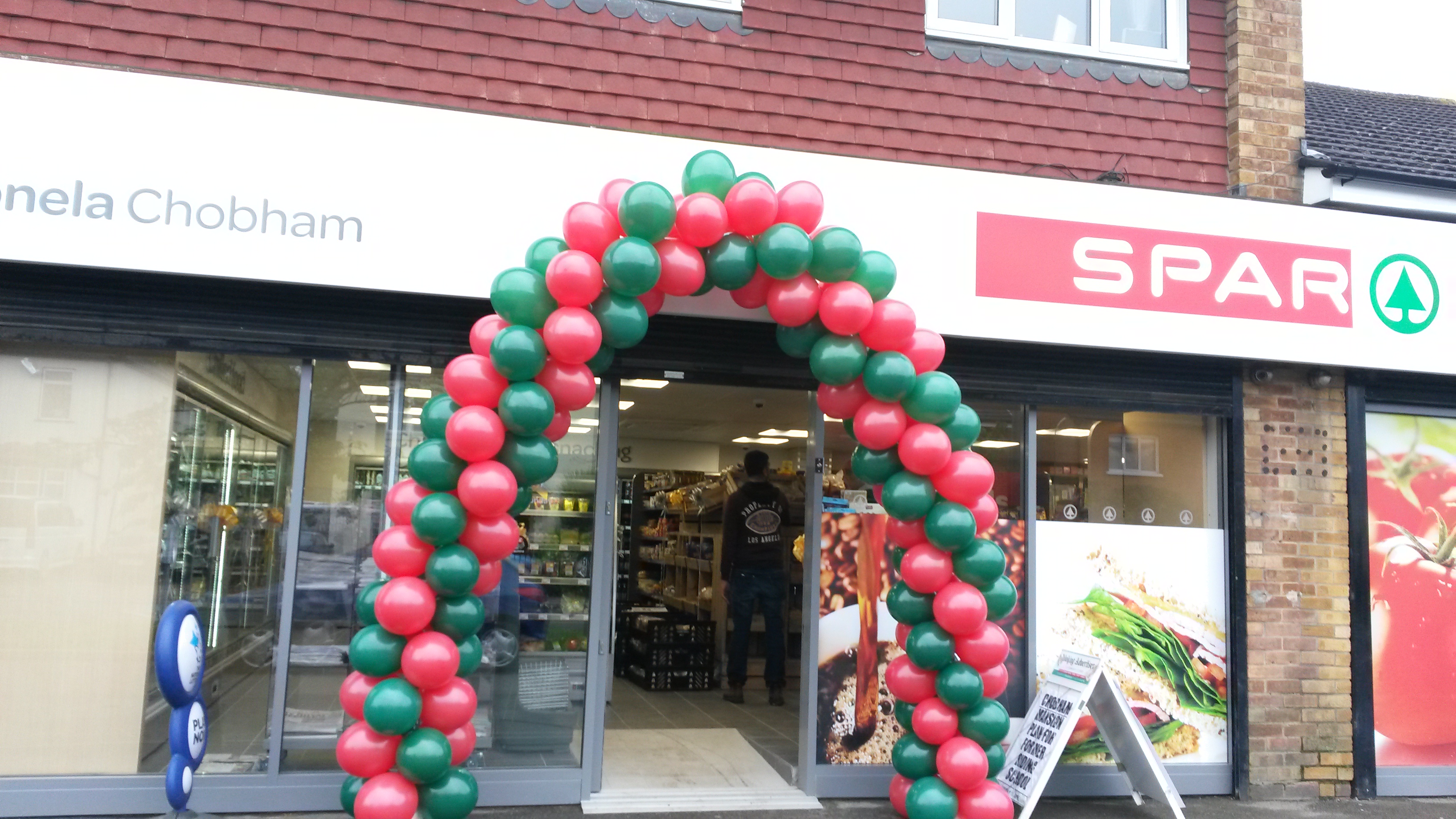 Red and Green Spiral Balloon Arch created for Spar Chobham